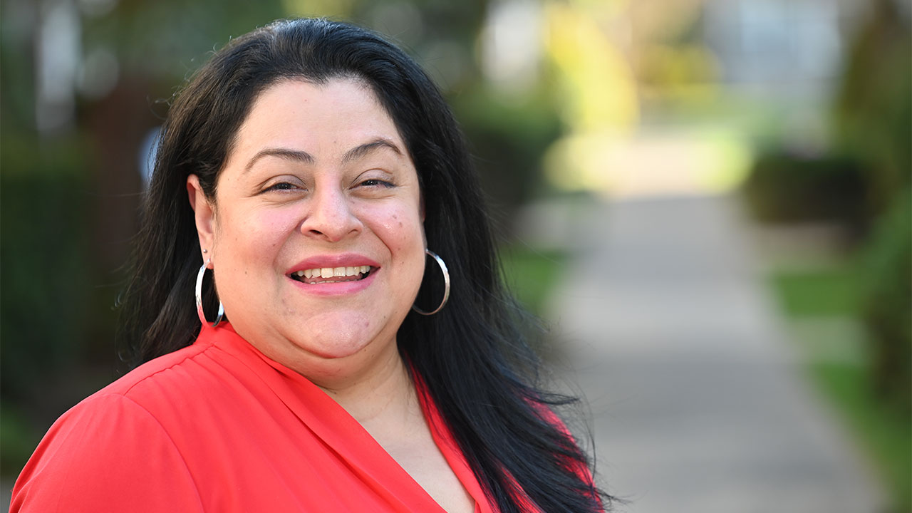 woman in a red blouse and black hair