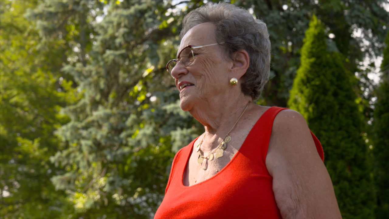 woman with glasses, short hair and red tank top