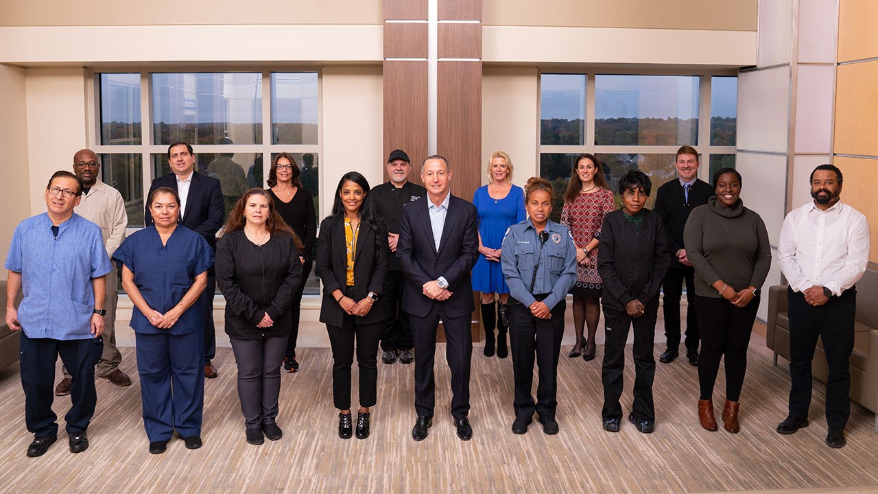 Warren Geller, president and CEO, Englewood Health, joined by team members from environmental services, food and nutrition, facilities, population health, and security.