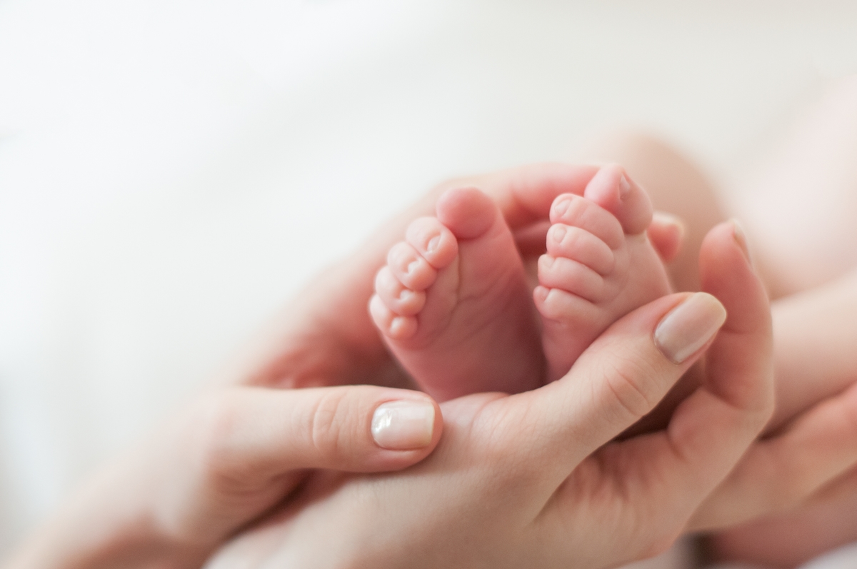 Mother holding baby's feet