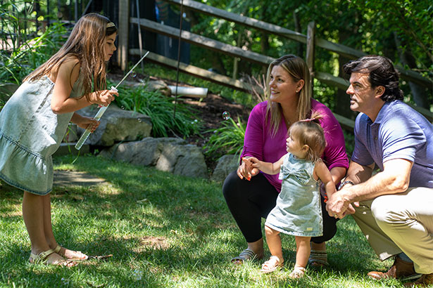Jocelyn playing in the yard with her family